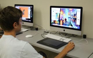 Boy going graphic art on a computer