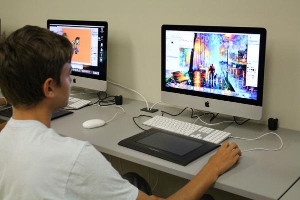 Boy going graphic art on a computer