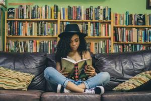 Teenager reading on sofa