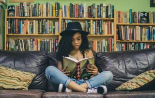 Teenager reading on sofa