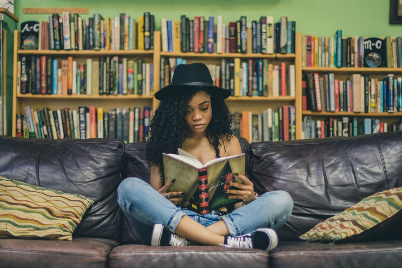 Teenager reading on sofa